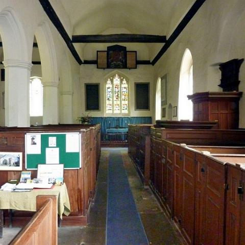 Nave and pulpit, St James Church. The pulpit is oak and dates to the 16th century. Photo 2010.