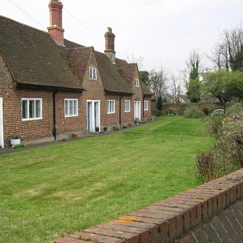 The Alms Houses, Roydon Road. Founded in 1635 by Sir Edward Baesh, who was a resident of the village; he left six almshouses for widows and decayed tradesmen. Although there are six doors the number of dwellings has been reduced. Photo 2006.