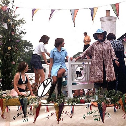 Womens Institute float by Queens Head pub. The lady in the smock dress is Liz Carter who kindly took care of me one night, when I was "slightly innebriated" after a session in the Village Club. Sadly no longer with us. The chap on the pub roof is Ted Chandler. Photo 1970's.