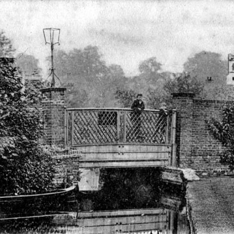 Mill Bridge, Stanstead Abbotts. The bridge is no longer there. The Mill Stream now flows under the Roydon Road to the right of this old bridge as can be seen by the position of the church. Postcard part of "The Hatfield Seies". Postal date unclear but bears a 1905 Edward V11 stamp.